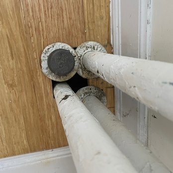 Exquisite Flooring - BEFORE: Large gap between pipes - Flooring Near Me Exquisite Flooring - BEFORE: Large gap between pipes - Flooring Near Me