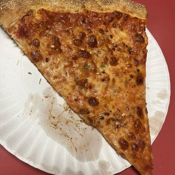 Tommy's Pizza - a slice of pizza on a paper plate - Pizza Near Me - Bronx, New York Tommy's Pizza - a slice of pizza on a paper plate - Pizza Near Me - Bronx, New York