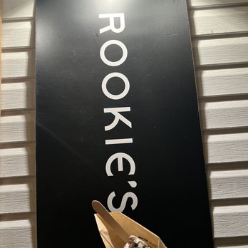 Rookie's - a hand holding a shoe in front of a sign - Ice Cream & Frozen Yogurt Near Me - Lynchburg, Virginia Rookie's - a hand holding a shoe in front of a sign - Ice Cream & Frozen Yogurt Near Me - Lynchburg, Virginia