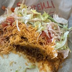 Taco John's - Taco with brown lettuce.