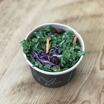 WILDBIRD - a bowl of kale salad on a wooden table - Salad Near Me - Los Angeles, California WILDBIRD - a bowl of kale salad on a wooden table - Salad Near Me - Los Angeles, California