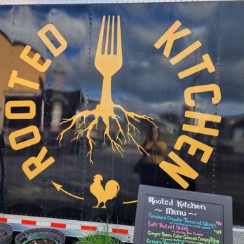Rooted Kitchen - a truck with a sign and potted plants - Food Trucks Near Me - Mount Vernon, Washington Rooted Kitchen - a truck with a sign and potted plants - Food Trucks Near Me - Mount Vernon, Washington