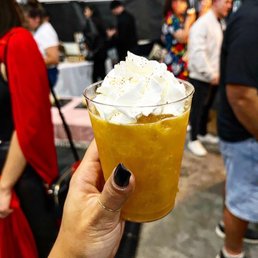 a person holding a cup of ice cream a person holding a cup of ice cream