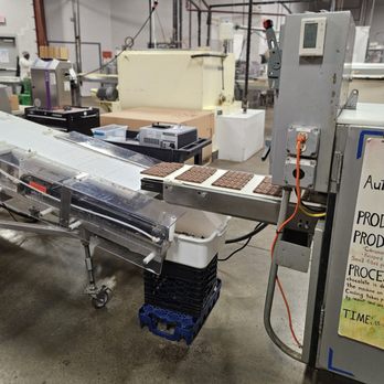 Fowler's Chocolates - a conveyor belt in a factory - Chocolatiers & Shops Near Me - Buffalo, New York