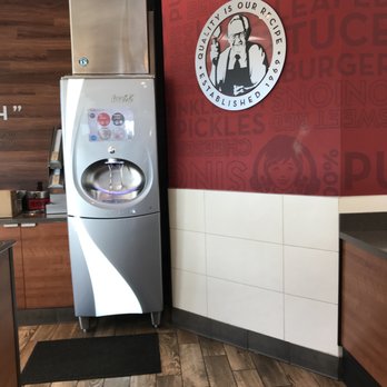 Wendy's - a kitchen with a refrigerator and a logo on the wall - Burgers Near Me - Irvine, California