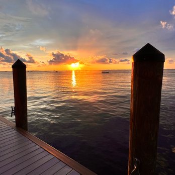Sundowners - a dock with a boat in the distance - Seafood Near Me - Key Largo, Florida Sundowners - a dock with a boat in the distance - Seafood Near Me - Key Largo, Florida