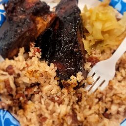 Jerk chicken, rice and peas, and cabbage.