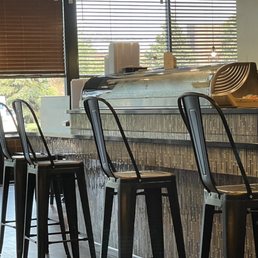 a row of metal stools in a restaurant
