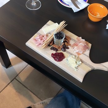 Class VI Wine & Charcuterie - a person sitting at a table - Wine Bars Near Me - DeKalb, Illinois