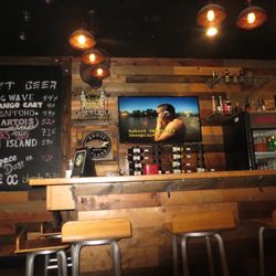 GU Ramen Taps & Tapas - Beautiful wood walls, bar, tv playing short skirt/ long jacket by cake
