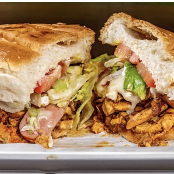 La Pinata Mexican Grill - Our torta Cubana filled with chicken, chorizo, ham, sausage, bacon, egg, lettuce, tomato, and mayonnaise. - Mexican Near Me - Louisville, Alabama La Pinata Mexican Grill - Our torta Cubana filled with chicken, chorizo, ham, sausage, bacon, egg, lettuce, tomato, and mayonnaise. - Mexican Near Me - Louisville, Alabama