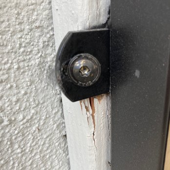 E & E Custom Iron Works - Poorly executed mounting.  Not centered on wood already cracking in multiple places. - Fences & Gates Near Me - La Puente, California