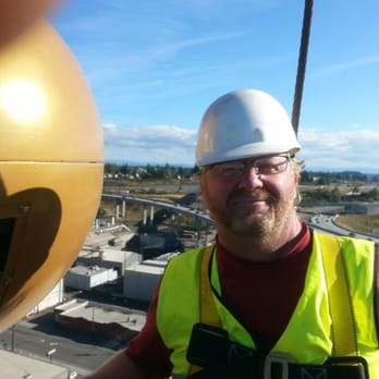 Shocking Difference - Darrell flying high at Tacoma Screw install lights on their 180 ft high flag pole - Electricians Near Me - Olympia, Washington