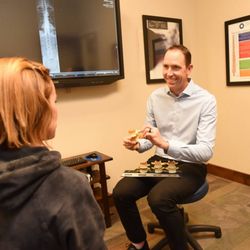 Dawson Chiropractic - Dr. Jerod Dawson discussing the spine with a patient.