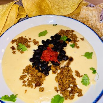 Jasper's - QUESO, CHIPS & RINDS cheesy goodness mixed with black beans, salsa, chorizo & cilantro - New American Near Me - Nashville, Tennessee