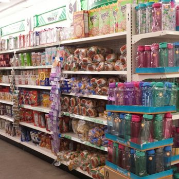 Dollar Tree - Breads & cereal section. - Display shelves in a retail store filled with bottled water and drink containers, including colorful bottles with caps, in a grocery or convenience store setting. - Discount Store Near Me - Albuquerque, New Mexico