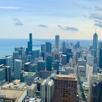 John Hancock Center - A cityscape of Chicago with numerous skyscrapers, including the Willis Tower, viewed from a high observation point near Lake Michigan. - Landmarks & Historical Buildings Near Me - Chicago, Illinois