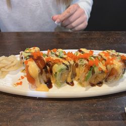 Sakura 10 - Sunrise Roll: Spicy yellowtail and crunch inside, topped with salmon, avocado, eel sauce, spicy mayo, wasabi mayo, scallions, and masago