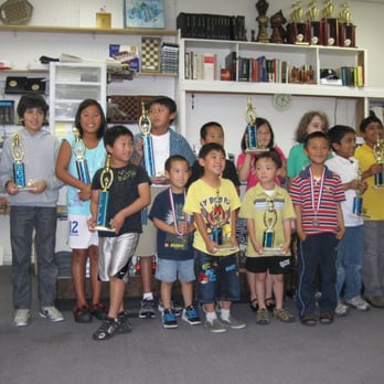 ChessPalace - Champions crowd around for a photo shoot - Tabletop Games Near Me - Garden Grove, California ChessPalace - Champions crowd around for a photo shoot - Tabletop Games Near Me - Garden Grove, California