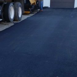 Advanced Asphalt Services - First section paved, loading paver for next section.