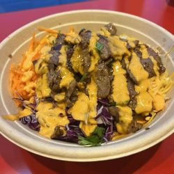 3 Sisters Express - Curry rice bowl, beef, peppers/onions, black beans, shredded carrots, cabbage, cheese and garlic pepper boom-boom sauce drizzled on top.