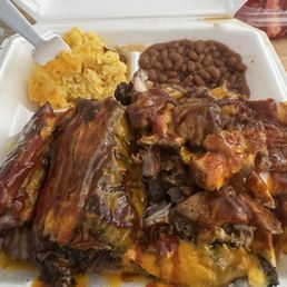 Two meat meal with chicken and ribs and baked beans and Mac for the sides. Highly recommend! Two meat meal with chicken and ribs and baked beans and Mac for the sides. Highly recommend!