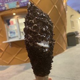 Chocolate and vanilla swirl with chocolate sprinkles in a fancy cone with oreo crumbs. Chocolate and vanilla swirl with chocolate sprinkles in a fancy cone with oreo crumbs.