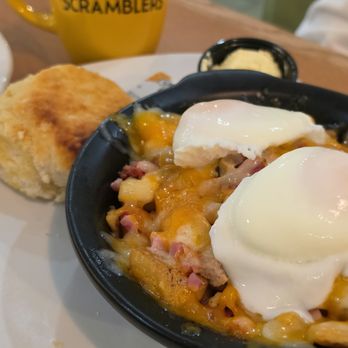 Scramblers - Uncle Moose's Skillet with 2 poached eggs. Under the eggs are the potatoes covered in a meaty sort of hash with cheese on top. - Breakfast & Brunch Near Me - Farmington Hills, Michigan Scramblers - Uncle Moose's Skillet with 2 poached eggs. Under the eggs are the potatoes covered in a meaty sort of hash with cheese on top. - Breakfast & Brunch Near Me - Farmington Hills, Michigan