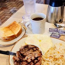 Iron Skillet - 12/10/24 Grilled pork chop breakfast Over easy eggs hash browns sourdough toast cawfee