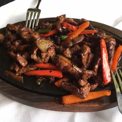 Wonderfully stir fried beef on a sizzling plate