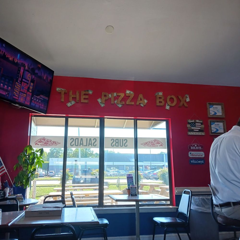 The Pizza Box - Gold letters say The Pizza Box, you can faintly see the smoker in the background. - Pizza Near Me - Virginia Beach, Virginia The Pizza Box - Gold letters say The Pizza Box, you can faintly see the smoker in the background. - Pizza Near Me - Virginia Beach, Virginia