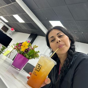 Pride Protein - a woman sitting at a table with a drink - Juice Bars & Smoothies Near Me - Bound Brook, New Jersey Pride Protein - a woman sitting at a table with a drink - Juice Bars & Smoothies Near Me - Bound Brook, New Jersey