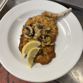 Oggi Bistro - Tomahawk pork chop with mushrooms - Italian Near Me - Grimsby, Ontario Oggi Bistro - Tomahawk pork chop with mushrooms - Italian Near Me - Grimsby, Ontario