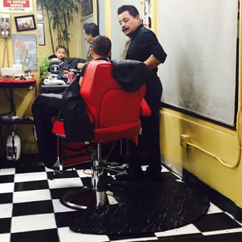 Aguilera's Barber Shop - Our barber, Enrique giving his work final approval. - Barbers Near Me - Los Angeles, California Aguilera's Barber Shop - Our barber, Enrique giving his work final approval. - Barbers Near Me - Los Angeles, California
