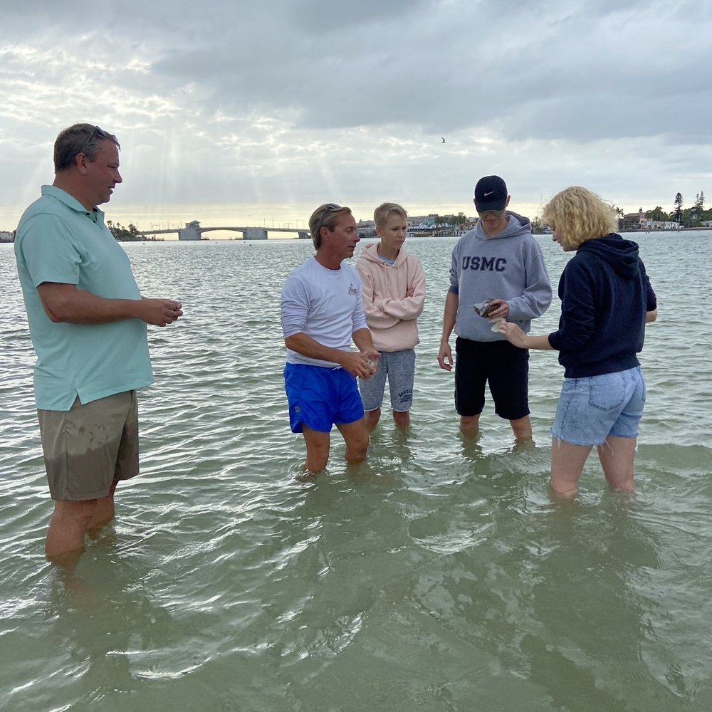 Sea-N-Things - Greg educating the family on the shells we found - Boating Near Me Sea-N-Things - Greg educating the family on the shells we found - Boating Near Me