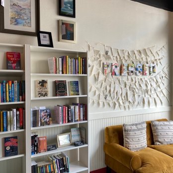 Pressed Books & Coffee - a living room with a yellow couch and bookshelf - Bookstores Near Me - Lakeland, Florida Pressed Books & Coffee - a living room with a yellow couch and bookshelf - Bookstores Near Me - Lakeland, Florida