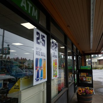 7-Eleven - a woman walking past a grocery store - Convenience Stores Near Me - Sandy, Oregon