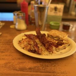 Western Cafe - The Bobcat -- cinnamon roll French toast w/ hash browns, two farm fresh eggs over easy, and bacon and an iced tea.