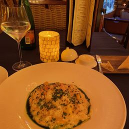 a plate of food and a glass of wine a plate of food and a glass of wine