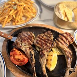 Milos Meze - Arnisia Paidakia: Grilled lamb chops with lemon-oregano vinaigrette and Kokkari potatoes.  $42  Greek Fries in the back
