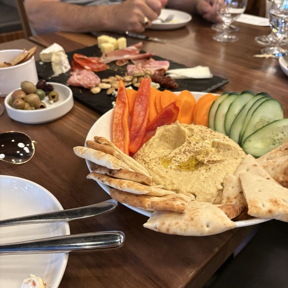 This is a picture of the hummus plate and the cascades board the in the background. This is a picture of the hummus plate and the cascades board the in the background.