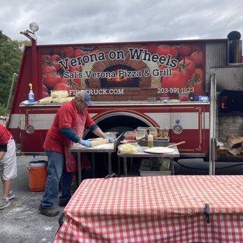 Pizza Fire Truck - people preparing food in front of a fire - Pizza Near Me - Waterbury, Connecticut Pizza Fire Truck - people preparing food in front of a fire - Pizza Near Me - Waterbury, Connecticut