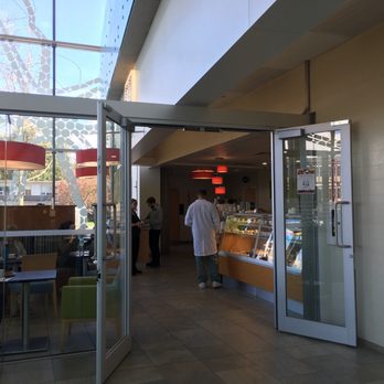 Cafe Ami - a man walking through a glass door - Coffee & Tea Near Me - Vancouver, British Columbia