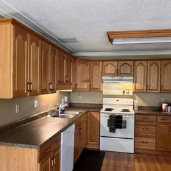 Painting Buddies - Cabinet painting by Painting Buddies. This is the before photo of cabinets in a basement in Burnaby.