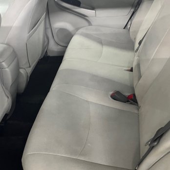 Cleaned back seat of a Toyota Prius. The beautiful cream interior is on display.