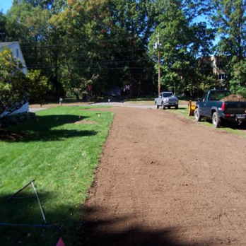 Stumpbuster - a man working on a driveway - Tree Services Near Me