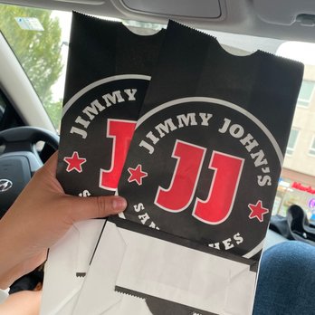 Jimmy John's - a person holding a bag of pizza - Sandwiches Near Me - Corvallis, Oregon