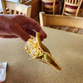 Robertos Mexican Food - a hand holding a taco - Mexican Near Me - Encinitas, California