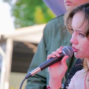 Be Natural Music - Young vocalist performing live on stage as part of a student music performance program. - Musical Instruments & Teachers Near Me - Cupertino, California Be Natural Music - Young vocalist performing live on stage as part of a student music performance program. - Musical Instruments & Teachers Near Me - Cupertino, California
