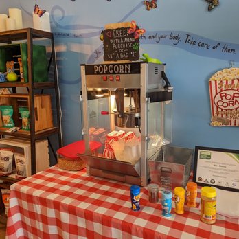 Bliss Blendz - a popcorn machine on a table with a checkered tablecloth - Salad Near Me - San Juan Bautista, California Bliss Blendz - a popcorn machine on a table with a checkered tablecloth - Salad Near Me - San Juan Bautista, California